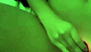 Amateur woman demonstrates toy use in homemade setting