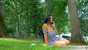 Sexy red bone babe fucks cock in the park, showing off her ebony pussy and boobs