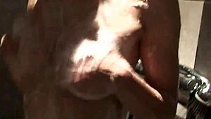 A cute babe with big boobs steps into the shower for a relaxing wash.