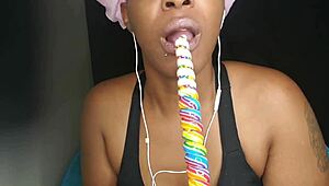 Cute ebony chick sucking lollipop with a naughty twist 😏