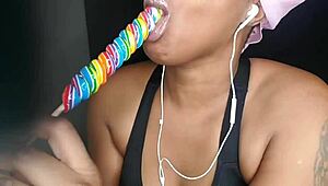 Cute ebony chick sucking lollipop with a naughty twist 😏