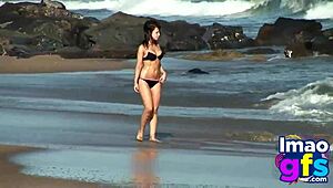 Hot brunette babe in lingerie on beach