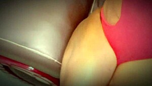 college ebony in red lingerie sits in chair