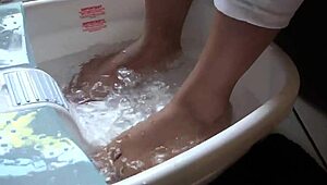 Asian woman enjoys messy barefoot foot bath