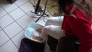 Asian woman enjoys messy barefoot foot bath