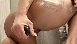 muscular blonde plays with her anal dildo in shower 😏