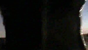 cd in latex walks outdoors with vibrator attached