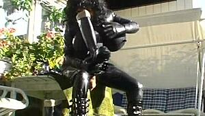 Roxina Torpedo Doll Stuns in Rubber Outfit at Garden Scene. Nature Meets Kink in Wild Display.