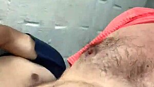 Rear view of gay deepthroat gagging and choking on hairy cock.