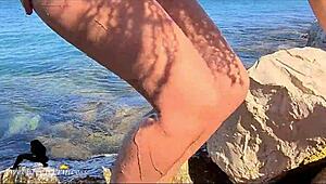 brunette pisses at the beach and teases her boyfriend by touching her pussy