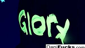 Sexy pornstar Dani casually plays with her wet pussy in a group setting.