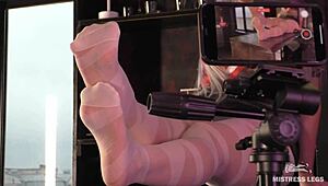 Goddess in white pantyhose teasing nylon toes on desk