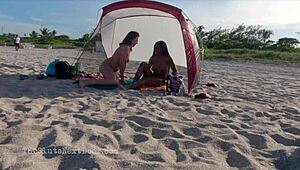 double handjob on public beach with big black cock