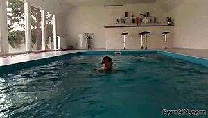 redhead and brunette lesbians fist each other in the public swimming pool