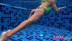 Asian girl boldly swims with big butt plug