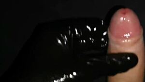 Gently masturbate horny big dick with latex gloves and lube.