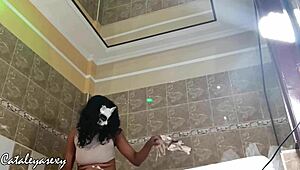 Ebony model with huge natural tits changes costume and poses seductively for the camera.