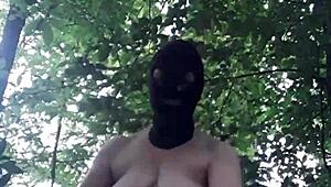 Female slave masturbates in outdoor forest bondage