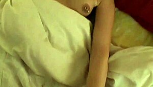 hot brunette fucks hardcore in bed, showing natural tits.