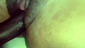 Playing with that tight pussy in a close-up black cock handjob.