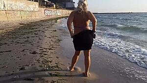 omg, im so horny watching this hot milf masturbate on the beach outside