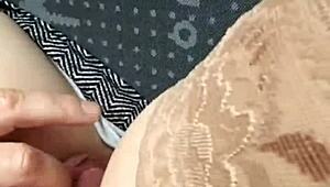 In the car, she removes her panties and pleasures herself on the street, inviting voyeurs to watch her intimate display