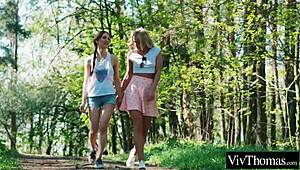 sexy blonde kisses hot brunette in forest, then they lick indoors