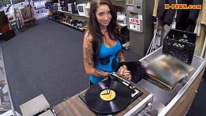 In the pawnshop, a busty woman with tattoos gets spied on while getting drilled hard.