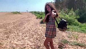 Hey, watch this naked girl stroke and pee on a public beach!