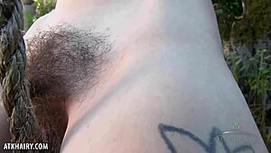 Aislynn spreads her hairy pussy wide outdoors for intense fingering