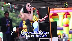 indonesian singers perform wild erotic dance on stage with eager crowd