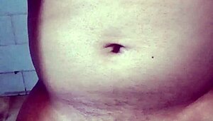 Old Indian gay bottom enjoys his own golden shower casually. He bends over for the flow.