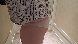 a hidden camera in the fitting room caught a mature chubby milf with a big booty trying on shorts.