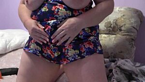 Chubby milf shakes big tits while fingering hairy pussy!