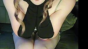 Pink shirt and black mini skirt on a sissy crossdresser with white legs