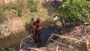 Hey, watch 2 strangers take turns banging this teenage village girl by the river.