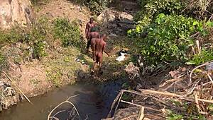 Hey, watch 2 strangers take turns banging this teenage village girl by the river.