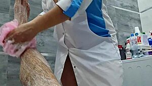 stepmom walks in to wash naked stepson, ignores huge cock in bathroom