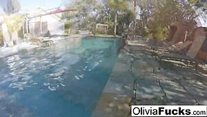 Olivia strips down for steamy solo fun in the pool. Her blonde curves shine under the summer sun.