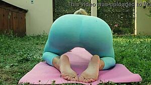 sexy blonde does yoga in blue leggings on green meadow, wanna see those big tits bounce?