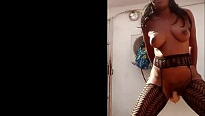 Masked ebony dildo fucks herself outside.