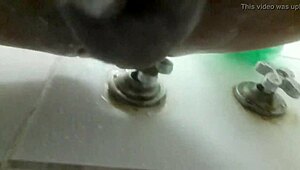 In the shower, he pleasures himself with a dildo