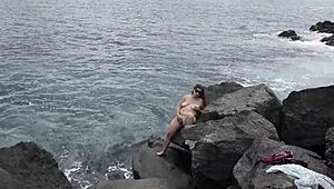 Unexpected cumshot hits nudist girlfriend's face on beach while cuckold watches!