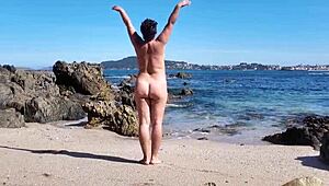 Curvy Nudist Wife Flaunts Hairy Pussy on Public Beach in Softcore Scene.