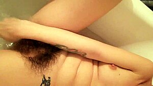 Hairy pussy with big clit drips wet in closeup