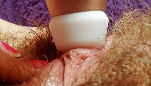 Hairy pussy with big clit drips wet in closeup