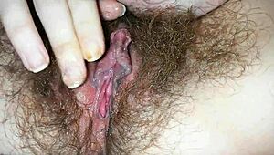 Hairy pussy with big clit drips wet in closeup