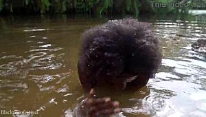 African girl bathes in river
