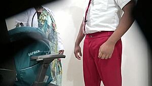 Lady doctor examines school student in hospital setting