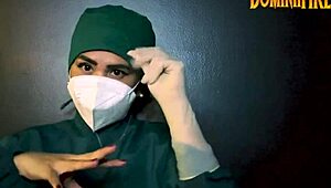 The latex-gloved femdom mistress dominates her submissive in a fetish session